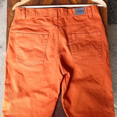 Man in Orange Shirt and Blue Denim Shorts · Free Stock Photo