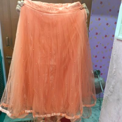 Peach net readymade lehenga with mirror & stone embroidered jaal design  crop top,3/4th collar shrug & floor-touch skirt