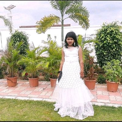 beautiful girl in white wedding dress on a pink background. Princess  wearing a crown and a long white dress Stock Photo | Adobe Stock