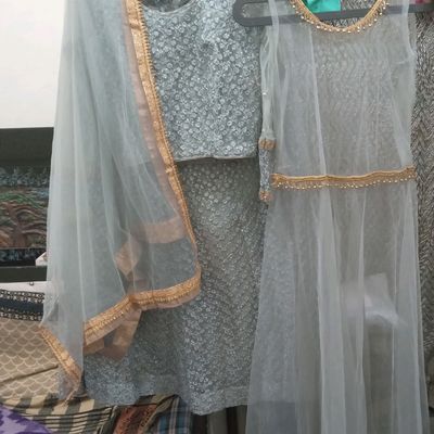 Silver lehenga with mirrorwork blouse and feather dupatta